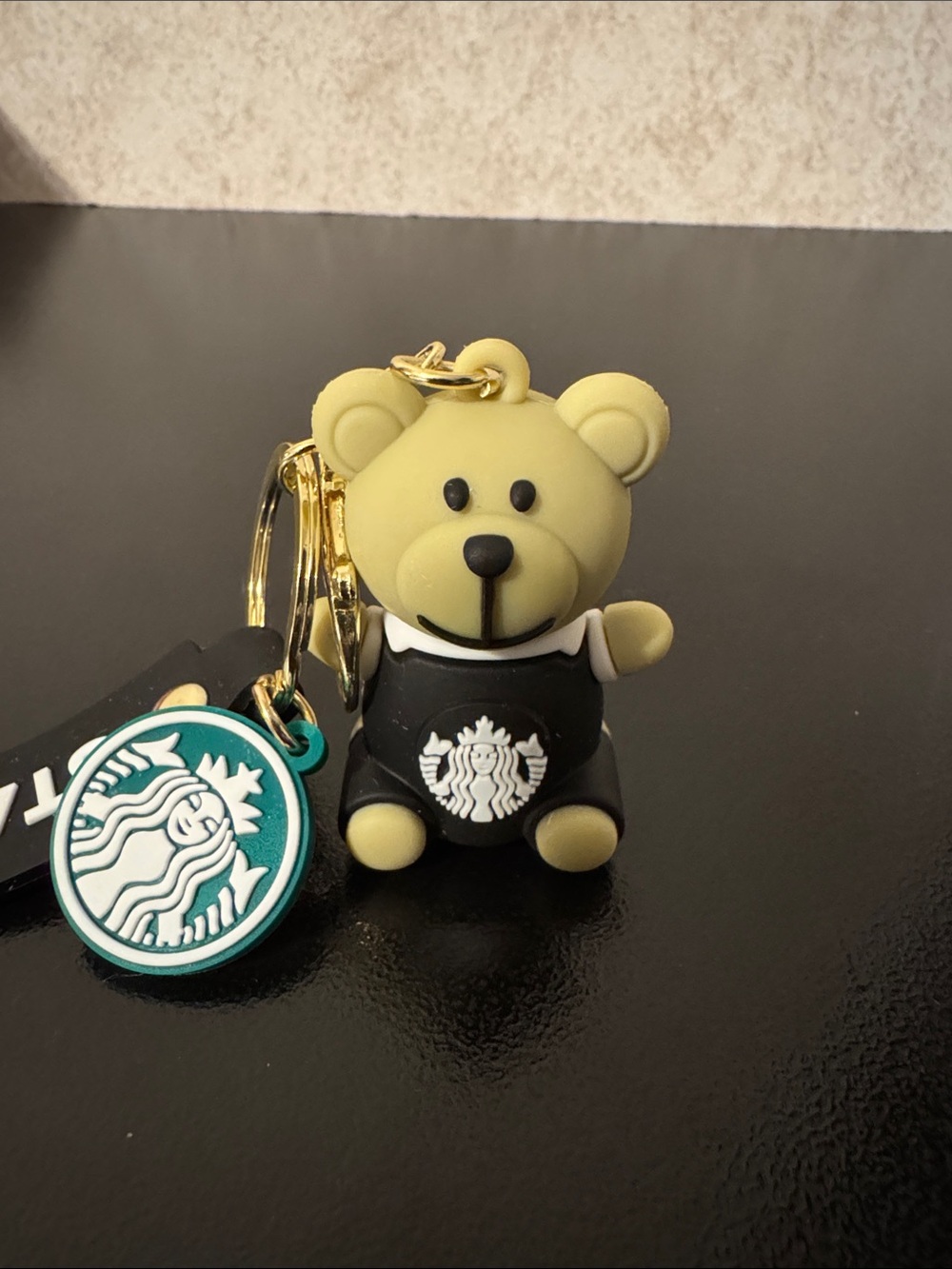 Bear Keychain with Black Outfit and Green Logo Charm